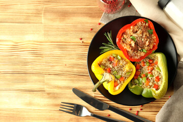 Concept of tasty food with ​stuffed pepper on wooden background