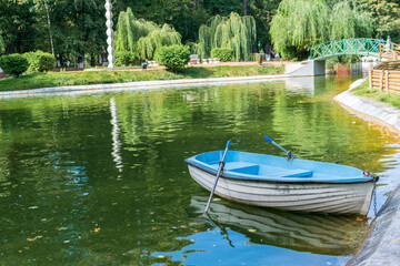 A blue boat at the edge of the lake, Roman park, Neamt, Romania
