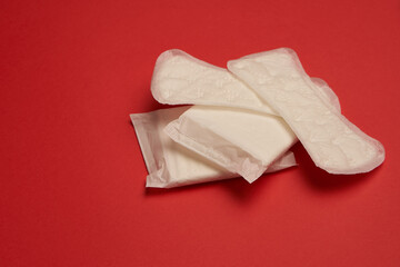 pads tampons underwear feminine hygiene red background