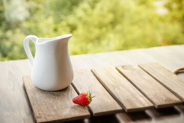 freshly picked organnic strawberry and milk on wooden table natural background, countryside, healthy eating. 