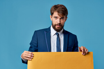 bearded man yellow billboard advertising copy-space blue background