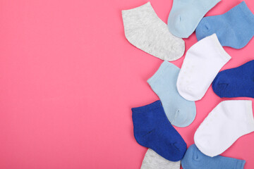 Color child socks on pink background, space for text