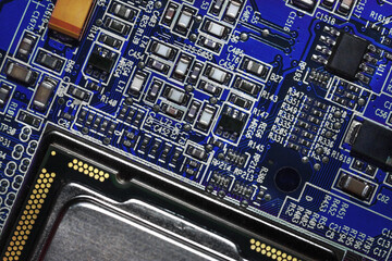 Close-up of a red electronic printed circuit board (PCB) with semiconductor strips between a microchip, transistor, and electronic equipment processor. IT technologies in programming, background