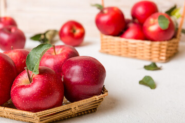Ripe garden apple fruits with leaves in basket on wooden table. Top view flat lay with copy space