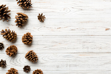 Christmas pine cones on colored paper border composition. Christmas, New Year, winter concept. Flat lay, top view, copy space