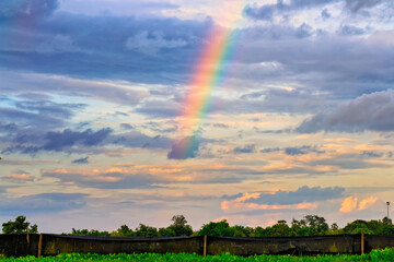 rainbow on cloudy sky background.