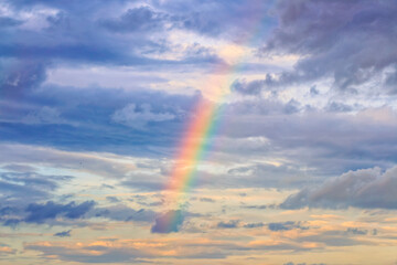 rainbow on cloudy sky background.