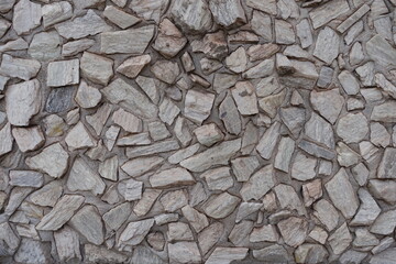 Close view of light gray gravel pebble dash