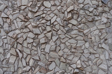 Closeup of light gray gravel pebble dash