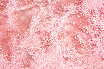 Pink lake - texture of pink salt as a background, unusual nature. A unique rare natural phenomenon. Salt lake with pink algae. Beautiful landscape.