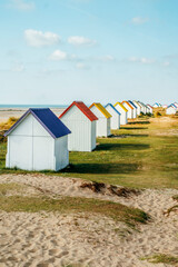 Row of colorful huts on the dune beach of Gouville-sur-Mer, Lower Normandy, France