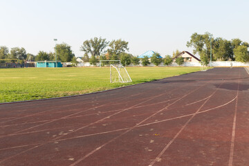brown running tracks with white markings in the stadium