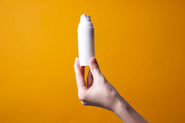 packaging of lotion or hand cream in female hands