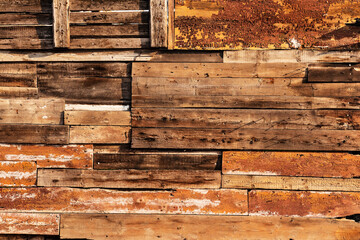 Vintage background from old rough wooden boards. Grunge texture of an old fence made of natural wooden bars and boards. Old wood fence background