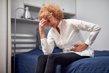 Woman with strong stomach pain at home.