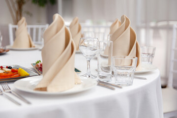 Luxury table setting for dining in pastel colors close up 