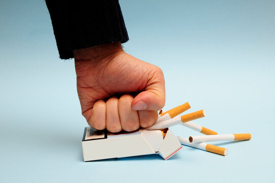 Hand Crushing A Cigarette Packet, Quit Smoking Concept