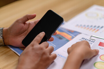 man using smartphone to work in office