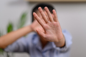 Young woman with making stop gesture with her palm outward