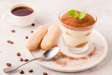 Traditional Italian dessert tiramisu in a glass.