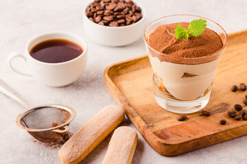 Traditional Italian dessert tiramisu in a glass.