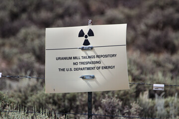 Selective focus shot of uranium mill tailings repository warning sign near Gunnison, Colorado, USA © Mindful Birder Photography/Wirestock