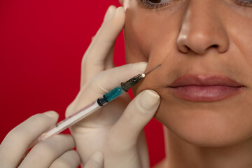 Obraz premium Portrait of a young woman on a face filler injection procedure
