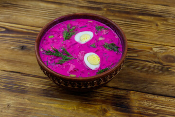 Cold beetroot soup on a wooden table