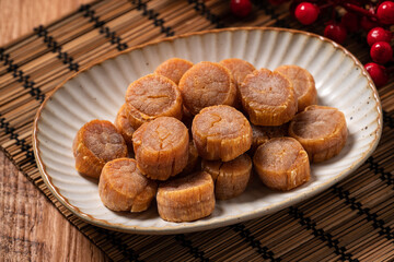 Dried scallop on wooden table.
