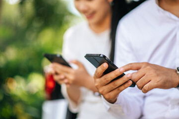 women and men sitting on mobile phones