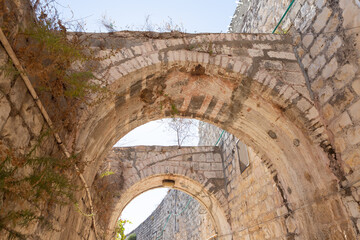 Stone  arched connections on the quiet small St James Street in the Armenian quarter in the old city of Jerusalem, Israel
