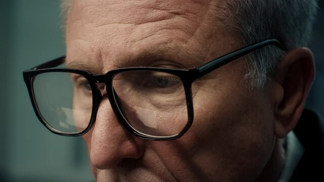 Closeup Of Mature Businessman Wearing Eyeglasses Working On Computer Indoors