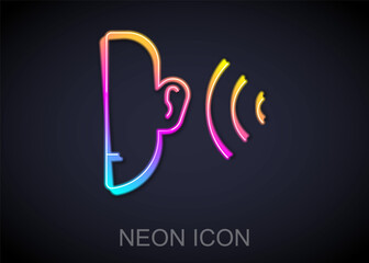 Glowing neon line Ear listen sound signal icon isolated on black background. Ear hearing. Vector