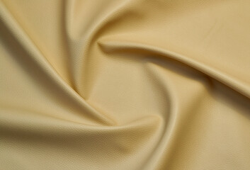 beige artificial leather with waves and folds on PVC base