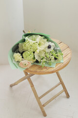 Beautiful flowers in living room interior. Bouquet of colorful fresh flowers on wood table. Home decor. Spring or holiday concept, March 8, International Womens Day, birthday.