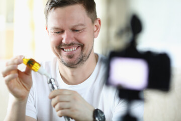 Cheerful guy using cbd cannabis oil