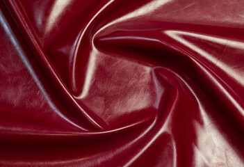 red artificial leather with waves and folds on PVC base
