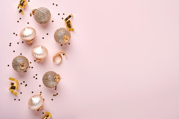 Christmas composition. Christmas gold gift or present box, gold baubles and confetti on pink background. Flat lay, top view. Magic Christmas greeting card. Border design. Mock up.