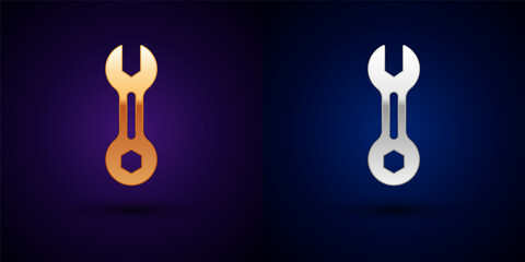 Gold and silver Wrench spanner icon isolated on black background. Vector