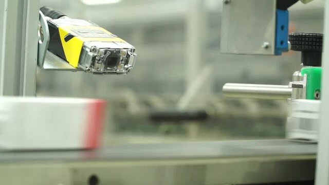 White pills moving on metal automatic line in workshop of pharmaceutical factory. Closeup view of drugs move along conveyor belt during work process in pharma chemical company. Concept: business