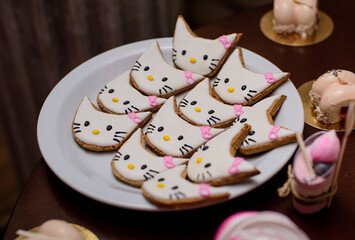 Cookies in the form of cats. Delicious sweets on candy bar.  