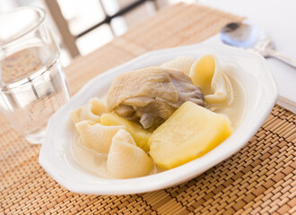 chicken broth soup with chicken, potatoes, and pasta shells