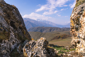 Rocks high in the mountains.. Mountain view on a clear autumn day. Mountains in Ingushetia. Landscape in the mountains in autumn. Rocks and trees in a mountainous area.