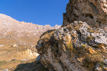 Rocks high in the mountains.. Mountain view on a clear autumn day. Mountains in Ingushetia. Landscape in the mountains in autumn. Rocks and trees in a mountainous area.