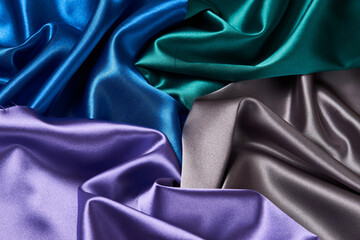 Colorful silk fabric background, top view