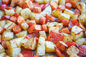 Fried carrots and potatoes close up image
