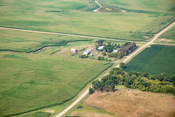 Aerial view of fields full of crops and farm houses in rural South Dakota.