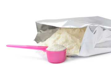 Bag of powdered infant formula and scoop on white background. Baby milk