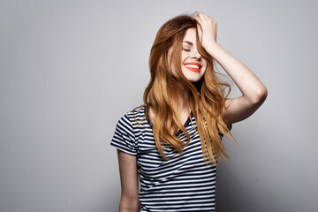 pretty woman in a striped t-shirt gesture with his hands isolated background