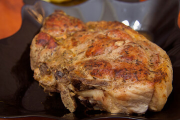Juicy ready roasted steak on the black plate in the kitchen